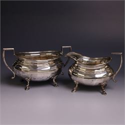 Early 20th century silver four piece tea service, comprising hot water pot, teapot, open sucrier and milk jug, each of part fluted oval form upon four stepped feet, the teapot and hot water pot with ebonised handle and finial, hallmarked Stephenson & Law, Sheffield 1918