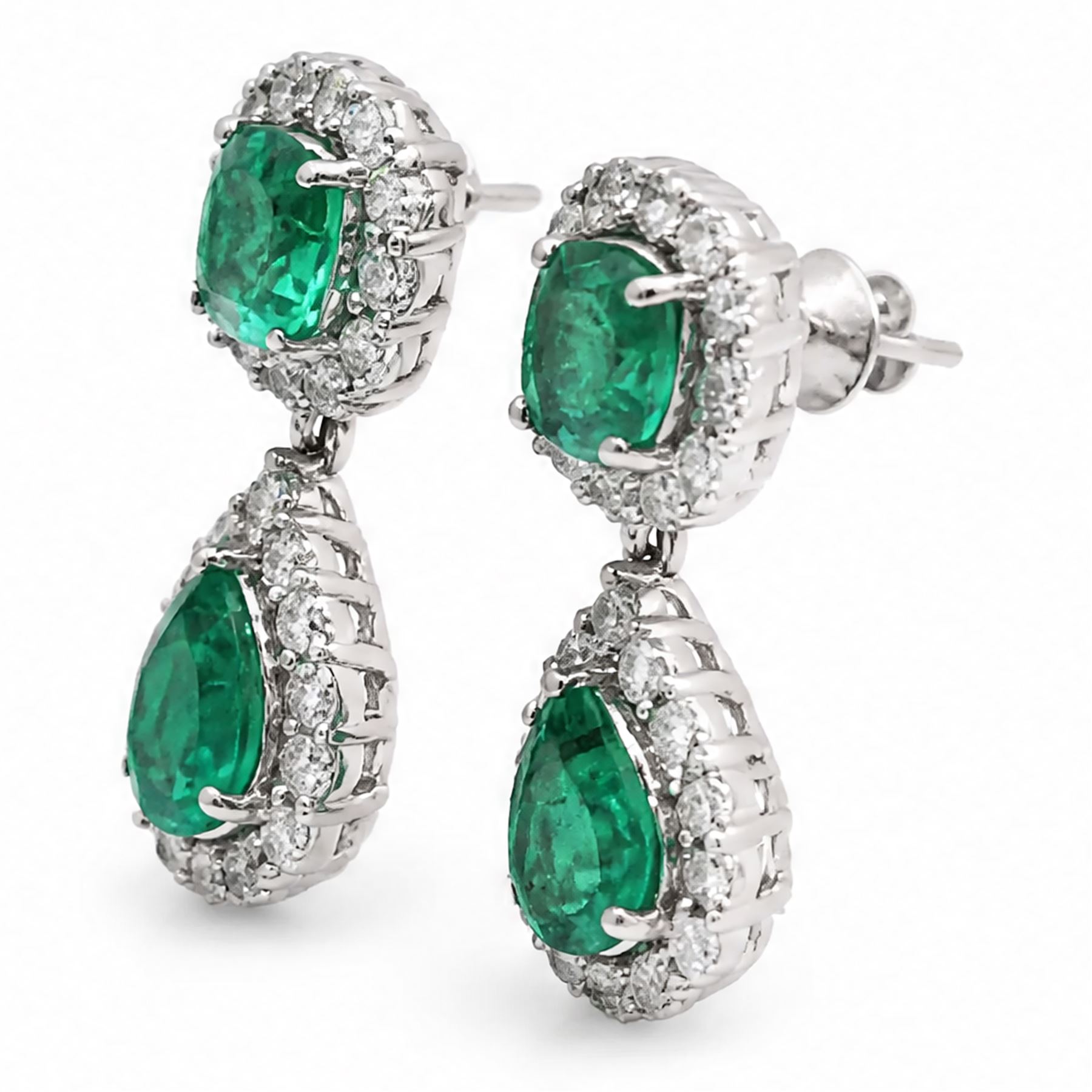 Pair of 18ct white gold emerald and diamond pendant earrings, each stud set with a cushion cut emerald and round brilliant cut diamond surround, suspending a further pear cut emerald and diamond cluster stamped, total emerald weight approx 3.45 carat, total diamond weight approx 1.70 carat