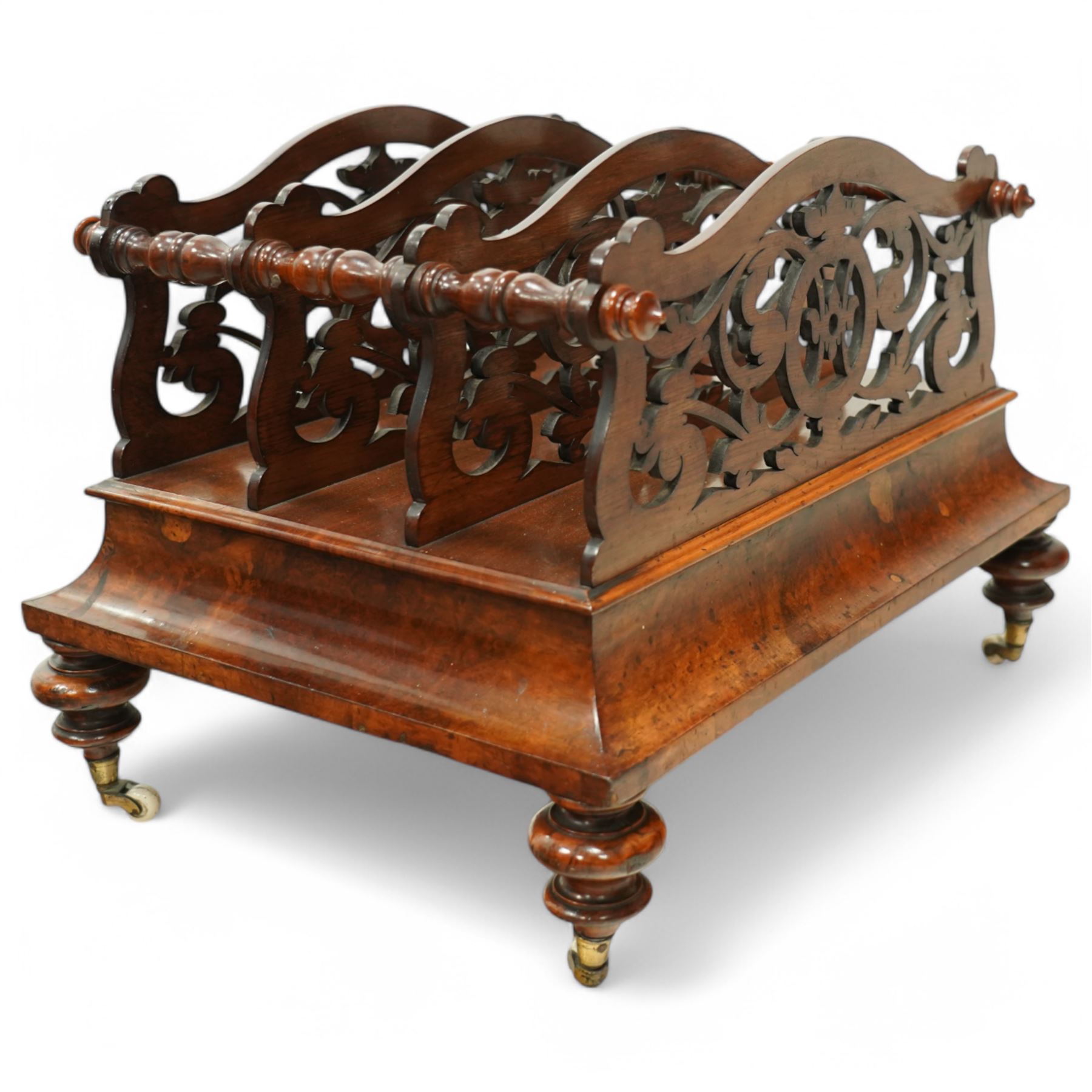  Victorian, walnut Canterbury- magazine rack with four fretwork upstands, drawer to base, standing on turned legs terminating in original castors. circa 1880