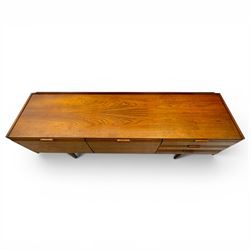 BCM (Bath Cabinet Makers) - mid-20th century teak sideboard, rectangular top with back gallery, left hand side fall front cupboard, centre cupboard opening to reveal a shelved interior, the right side with a bank of three drawers one fitted for cutlery, raised on inset tapering supports