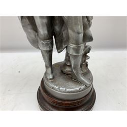 Early 20th century polished spelter figure of 'Napoleon' in a standing pose beside a rock on simulated marble wooden base with brass plaque; inset brass foundry disc H46cm
