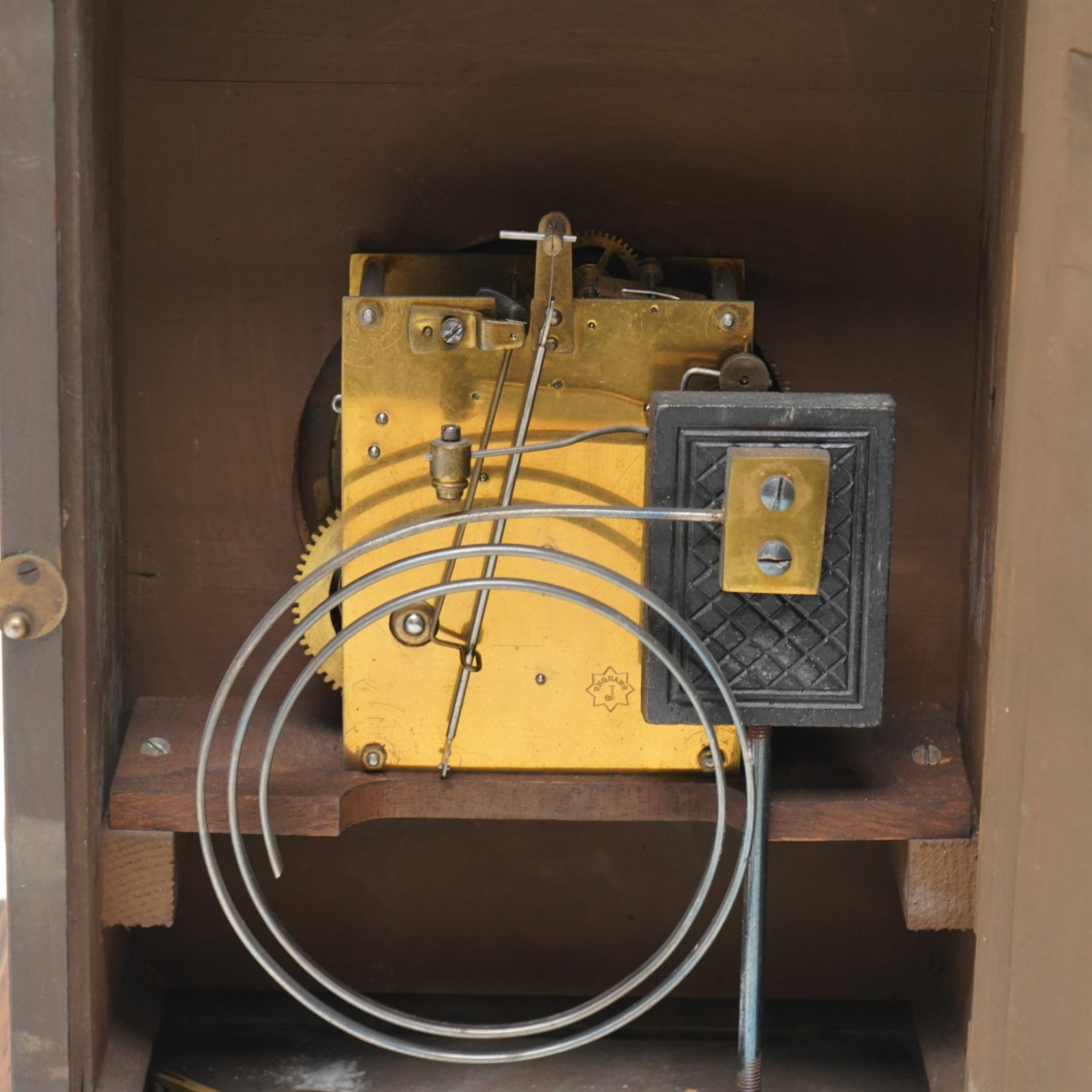 German-Junghans late 19th century oak cased mantle clock, with a domed pediment and three matching turned finials, break arch door beneath with attached turned and tapered pilasters, brass dial with cast spandrels, matted dial centre, steel hands and silvered chapter ring with Roman numerals, two train movement striking the hours and half-hours on a coiled gong. With pendulum and key.