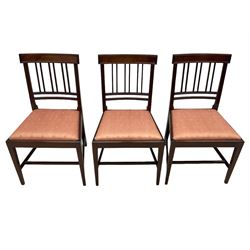 Early 20th century Regency design mahogany tilt-top table, circular top with edge banding, supported by a central turned pedestal with four reeded sabre supports terminating in castors; six chairs with pink upholstered drop in seats (7)