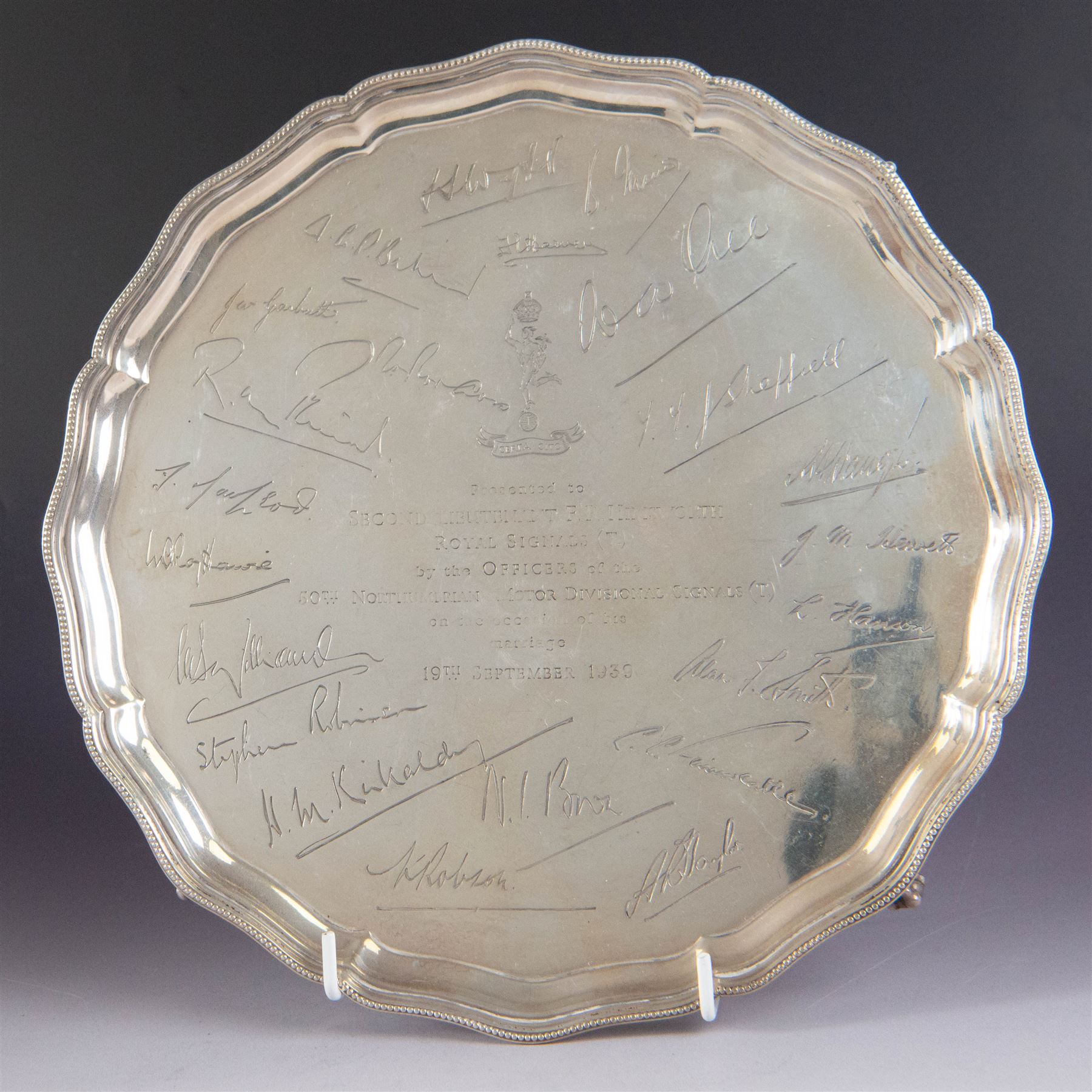 1930s silver salver, of circular form with beaded pie crust rim and upon four claw and ball feet, with presentation engraving to centre reading 'Presented to Second Lieutenant FR Himsworth Royal Signals by the Officers of the 50th Nottingham Motor Divisional Signals on the Occasion of his Marriage 10th September 1939', bordered by the engraved signatures of his colleagues, hallmarked Barker Brothers Silver Ltd, Birmingham 1938, D25cm