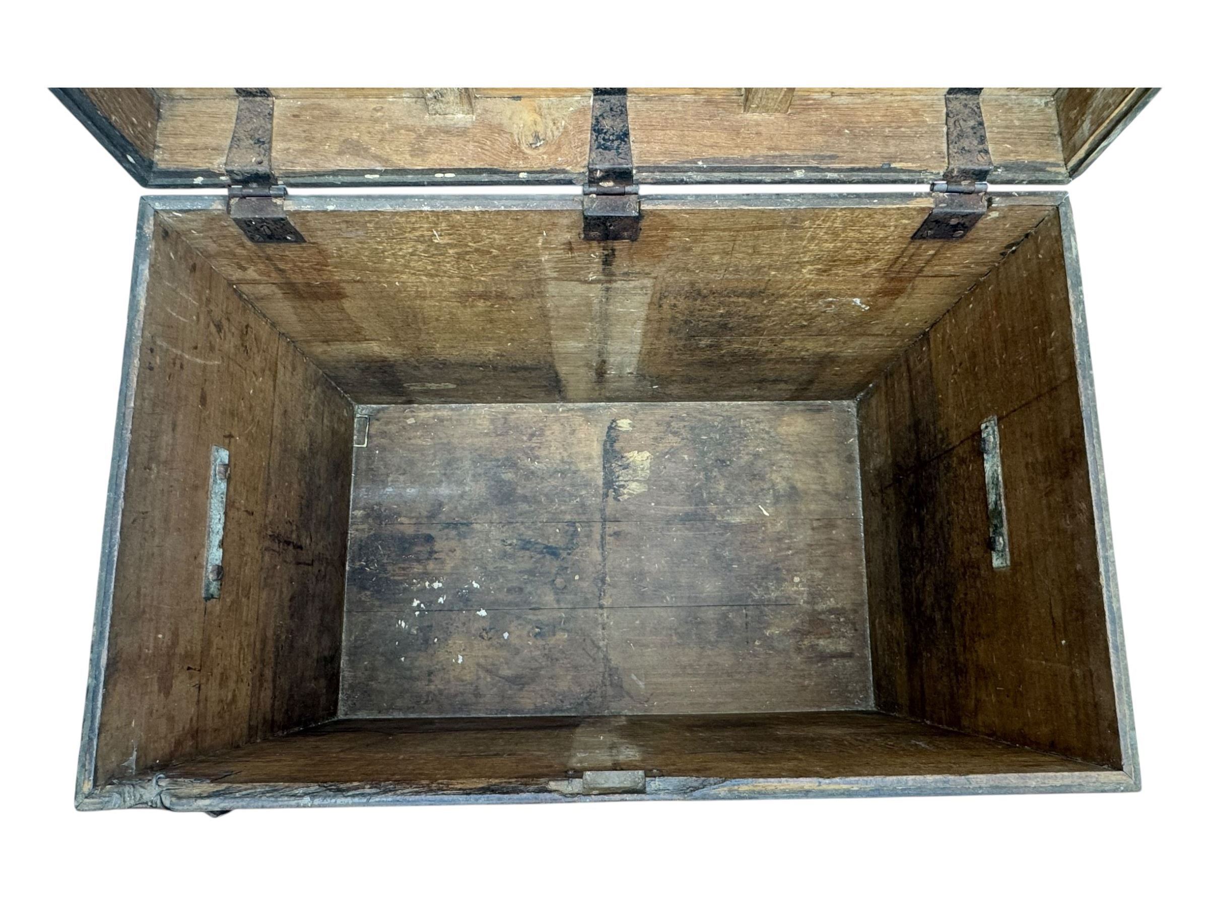 Early 20th century oak blanket chest, of rectangular form with iron strap hinges and surface-mounted drop handles, the interior fitted with iron lid stays, on bracket feet
