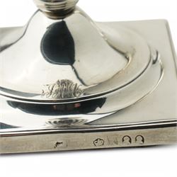 Pair of George III silver candlesticks with baluster stems and square bases, engraved with a monogram H20cm Sheffield 1793 and 1797, one double struck with kings head