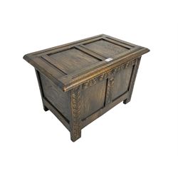 Small 20th century oak blanket box, panelled form, hinged lid, the front carved with foliate design