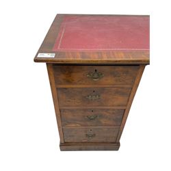 Late 19th to early 20th century walnut pedestal desk, rectangular top inset with red tooled leather writing surface, over a central frieze drawer flanked by two pedestals, each fitted with four graduated drawers with brass escutcheons and drop handles, the whole raised on a plinth base
