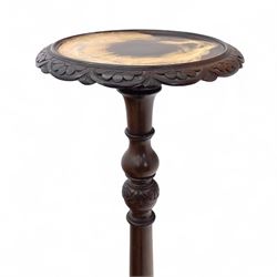 Early 20th century mahogany torchère and ceramic jardinière, circular dished top with carved leaf moulded edge, on ring turned and tapering column raised on tripod splayed supports, together with a hand-painted ceramic jardinière stand decorated with roses on a green ground (Torchère H 122cm, W 31cm, Jardinière H 71cm, W 30cm)