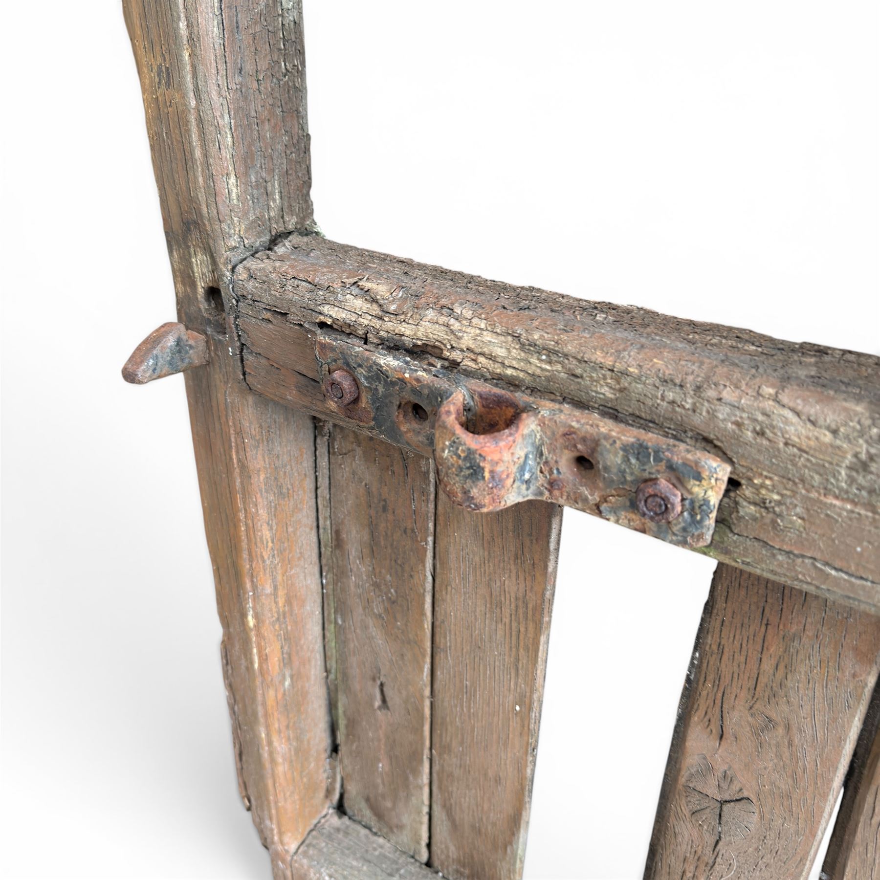 Pair of 19th century weathered wooden ecclesiastical church gates, the cresting rail over four pierced arches with slatted lower section, fitted with heavy cast iron hinges, latch and fittings