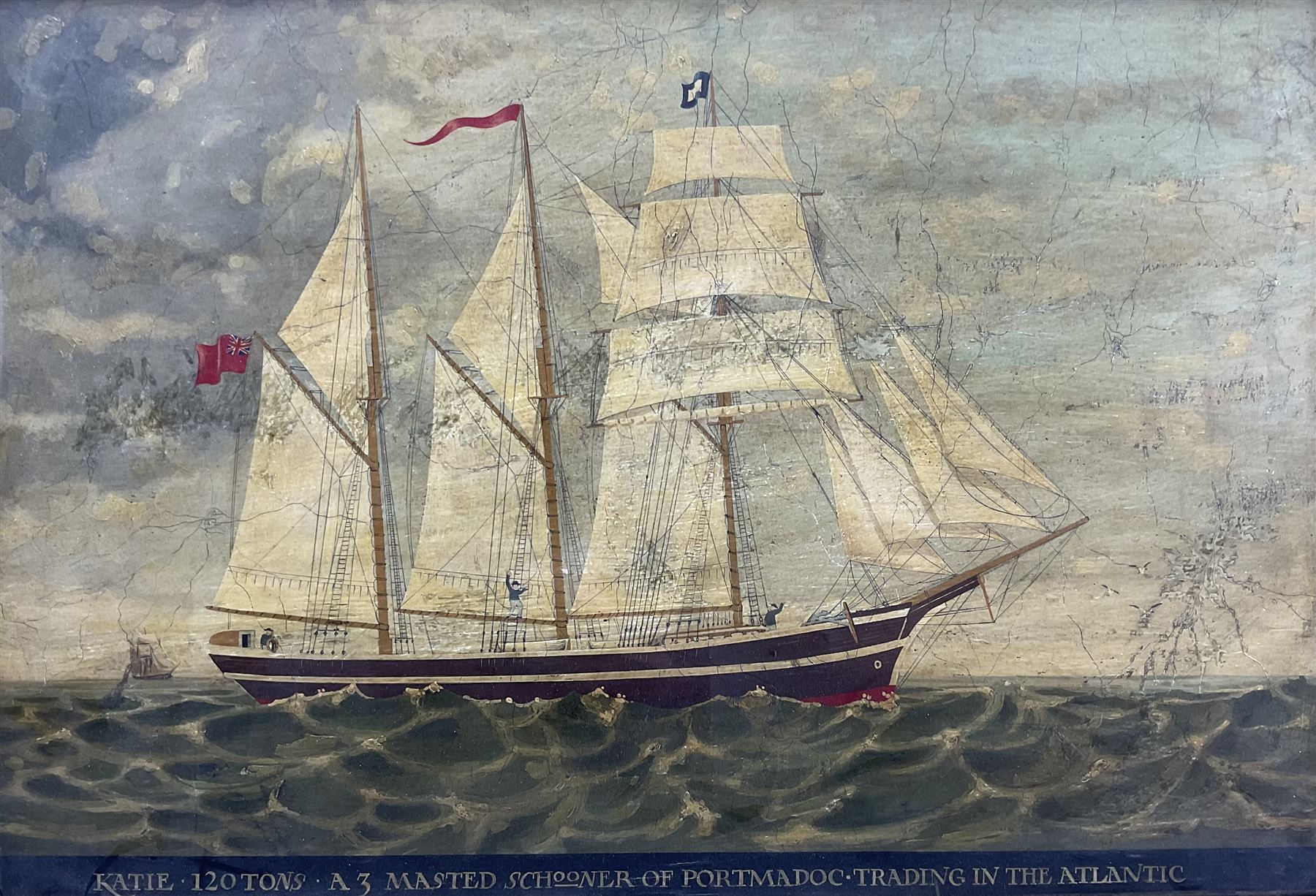 English School (20th Century): 'Katie 120 Tons - A Three Masted Schooner of Portmadoc Trading in the Atlantic', oil on panel titled along the lower edge 39cm x 57cm in birdseye maple veneered frame