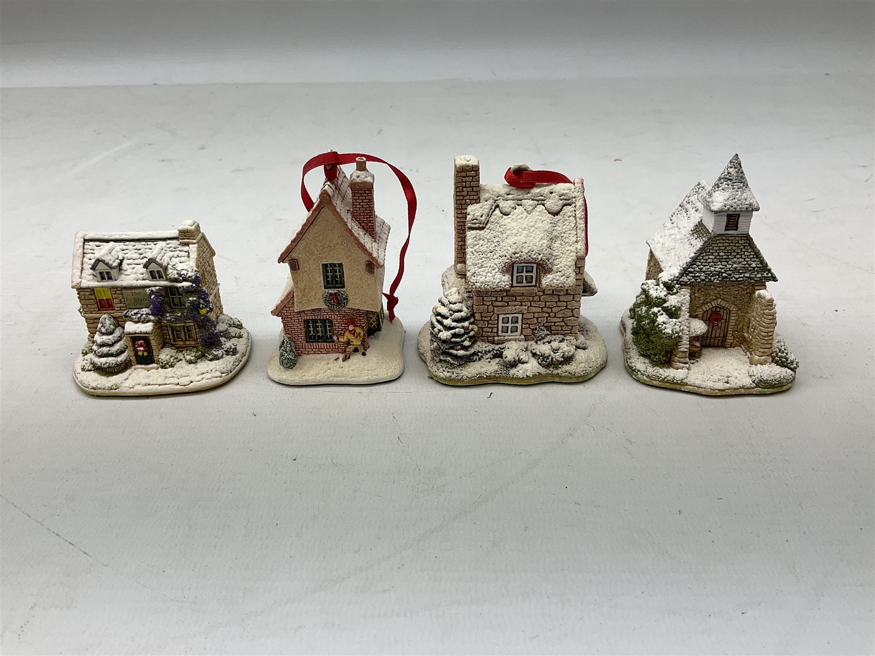 Sixteen Lilliput Lane models from Christmas collections, thirteen boxed and two loose, with various deeds, to include Snowdon Lodge, The Vicarage, Eamont Lodge etc