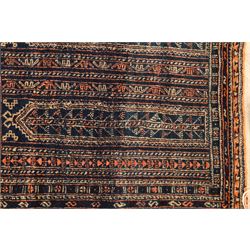North Persian indigo ground tribal rug, the field decorated with stylised geometric motifs within vertical rows, the guard stripes with repeating hook motifs