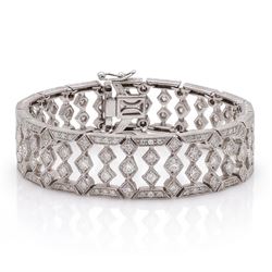 18ct white gold diamond bracelet, articulated and pierced design milgrain links set with round brilliant cut diamonds, the sides with engraved foliate decoration, stamped 750, total diamond weight approx 4.15 carat