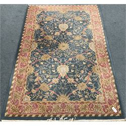 Blue ground rug overall foliate design with stylised leaf motifs within multiple border