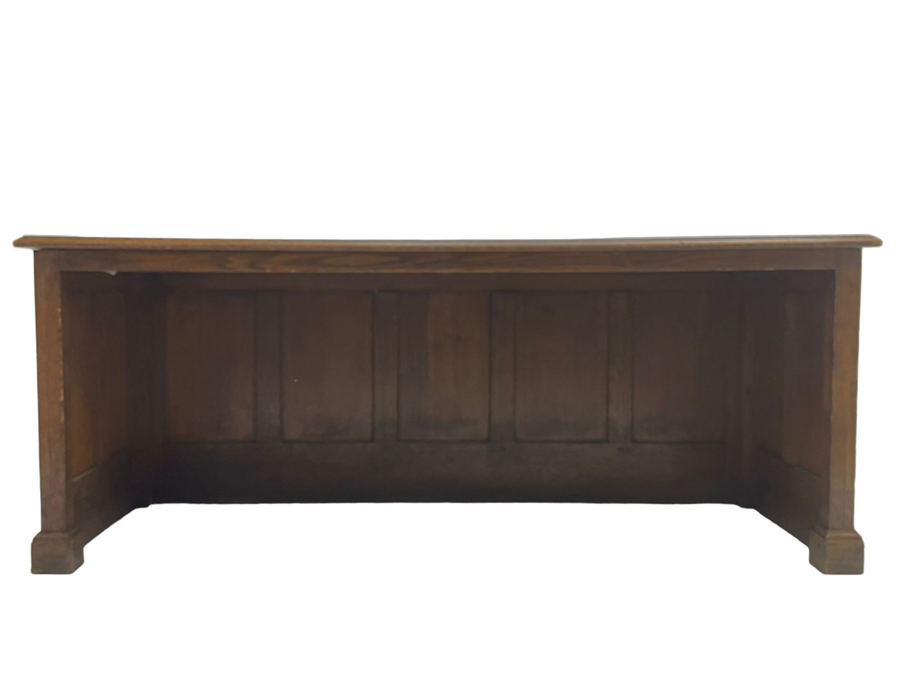 Illingworth Ingham and Co. School Furnishers (Leeds c1900) - early 20th century oak rostrum or headmaster's desk, rectangular top, the front and sides panelled with open reverse, on plinth base