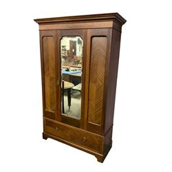 Edwardian mahogany single wardrobe, figured matched veneers to frieze, drawer front and panels, enclosed by bevelled mirror glazed door, base fitted with single drawer, on bracket feet