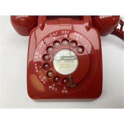 Two mid 19th century red telephones with rotary dials, comprising example marked G.P.O Batch Sampled 8532 706L AEG 67/2A, with junction box marked G.P.O, and another with chrome dial marked P.O Authorised Release 21034 746F EET 78/2