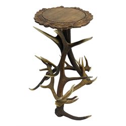 Stag antler occasional table, constructed with six antlers, circular stained beech top carved with leaves