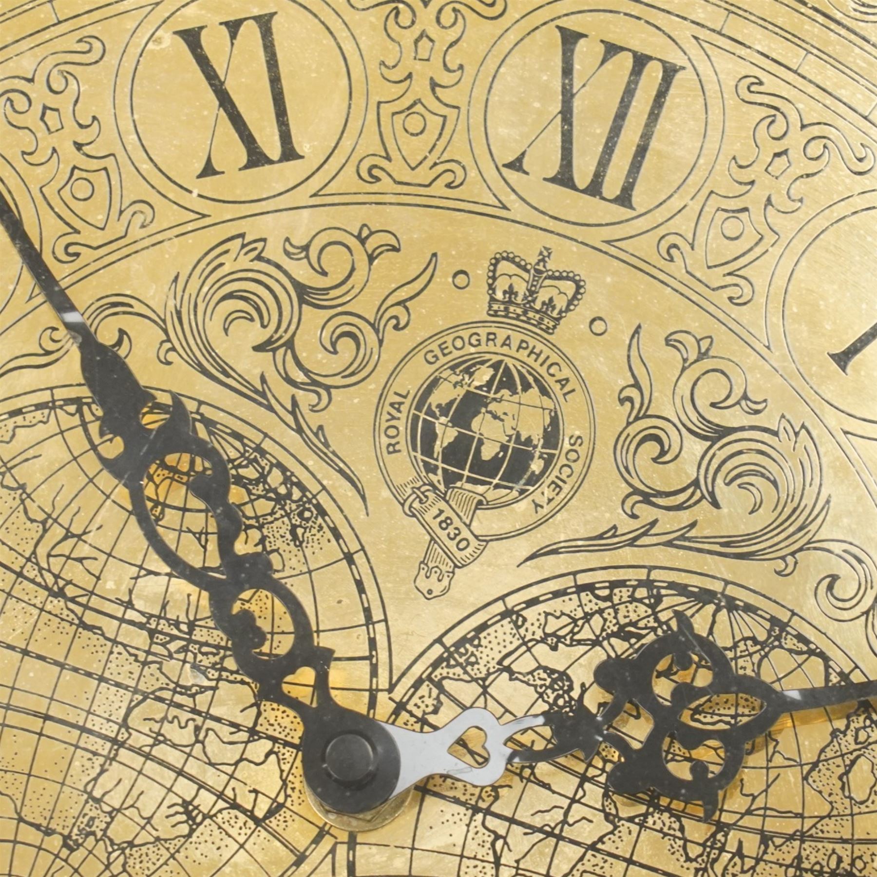 Royal Geographic Society - clock occasional table, the inset brass face with double hemisphere design and glazed top, raised on cylindrical supports united by triform platform base