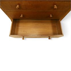 Mouseman - early-to-mid 20th century adzed and panelled oak chest, raised back over rectangular adzed top with canted corners, fitted with two short over three long drawers with turned knob handles, raised on octagonal feet, with carved mouse signature, by the workshop of Robert Thompson of Kilburn