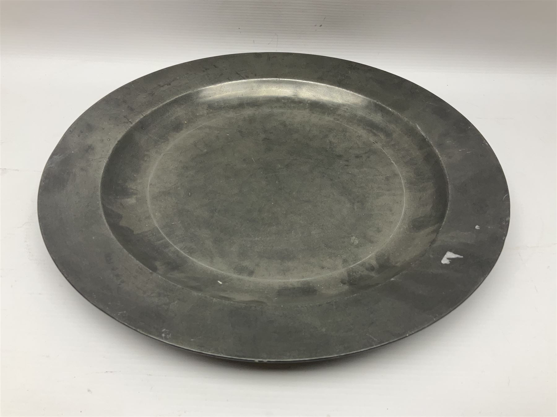 Group of seven 19th century pewter chargers, each of circular form with dished centre, two examples with touch marks verso, each approximately D39cm