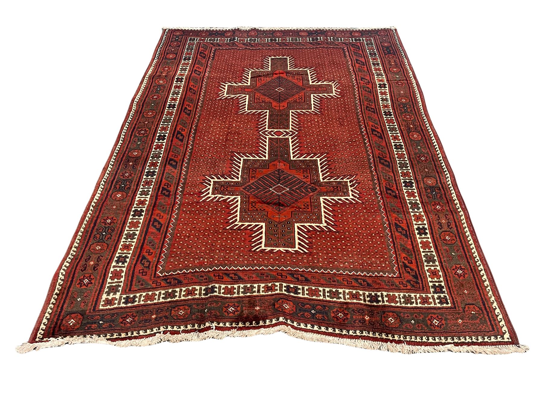 Persian Kelardasht red ground rug, the field decorated with two geometric medallions, multi-band border decorated with stylised flower heads and geometric repeating patterns