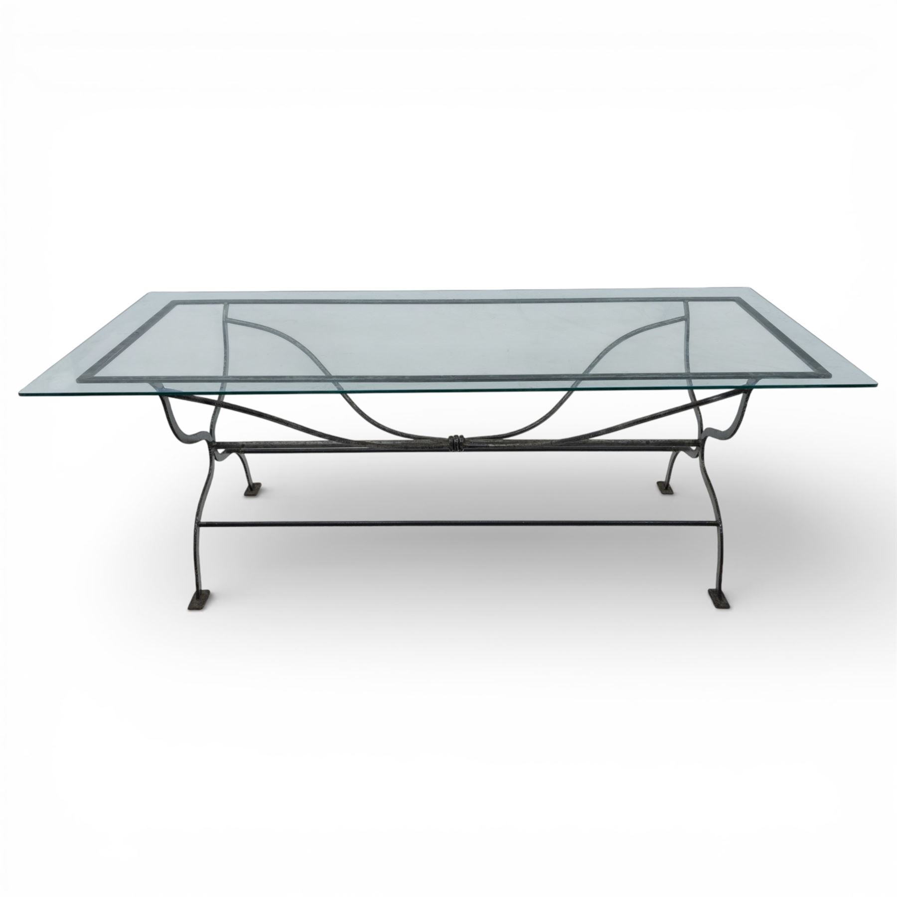 Late 20th century glass dining table, toughened glass top with rounded corners on a wrought metal designed base 