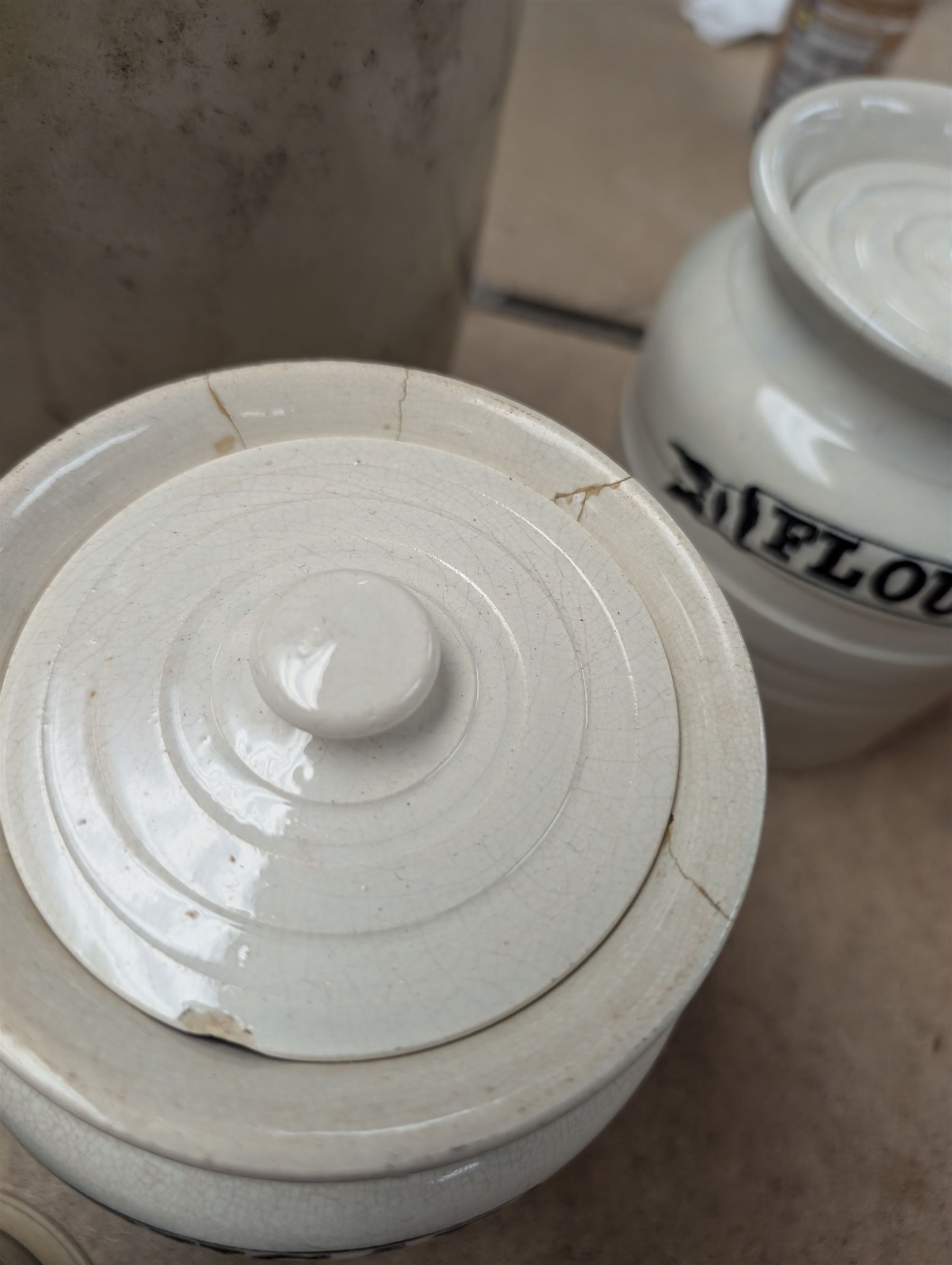 19th century sage green apothecary jars with gilt labels, four white ceramic kitchen jars and a stoneware flaggon marked Wheat Wine