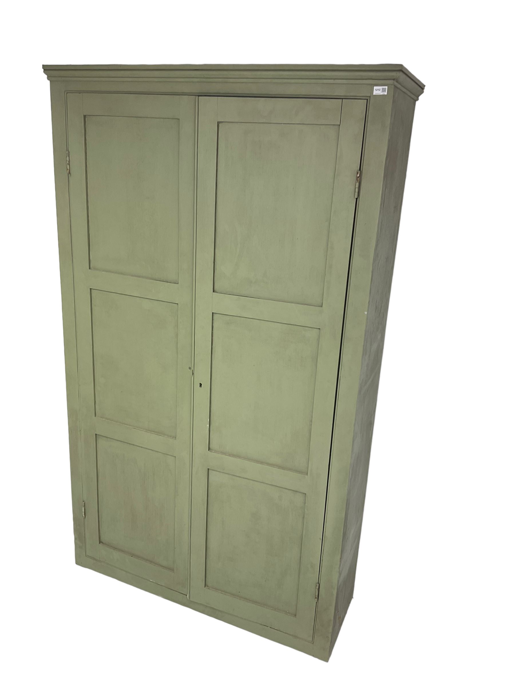 Painted pine cupboard, two panelled doors enclosing four shelves, in laurel green finish
