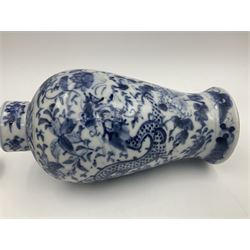 Late 19th/early 20th century Chinese blue and white vase and cover, of baluster form, the body painted with dragons amidst flowers, the domed cover with foo dog finial, with Kangxi character mark beneath, H22cm