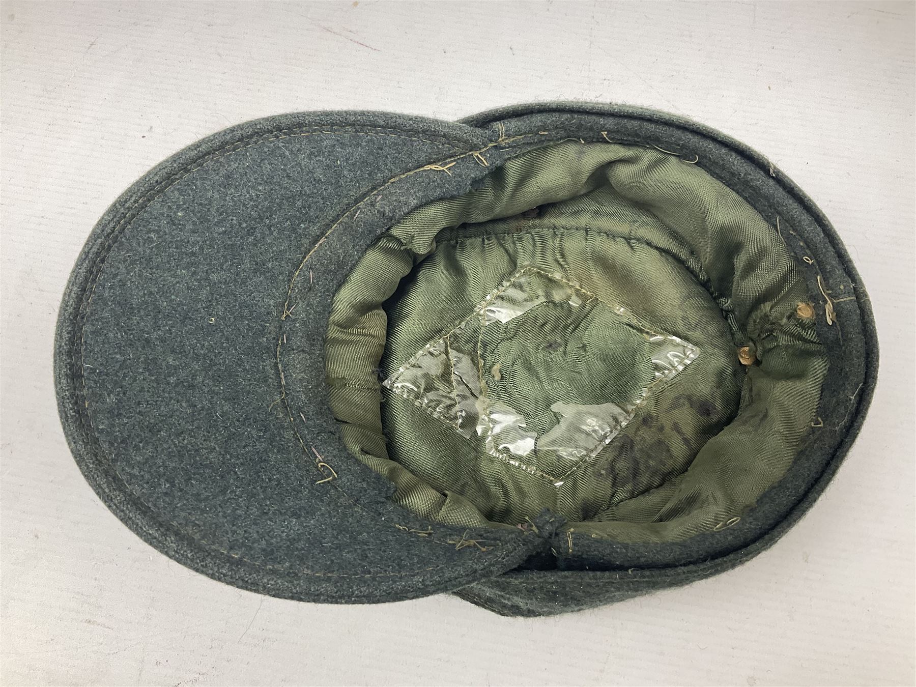 WWII German M43 field cap with 'SS' cloth badge and mountain trooper's edelweiss metal badge