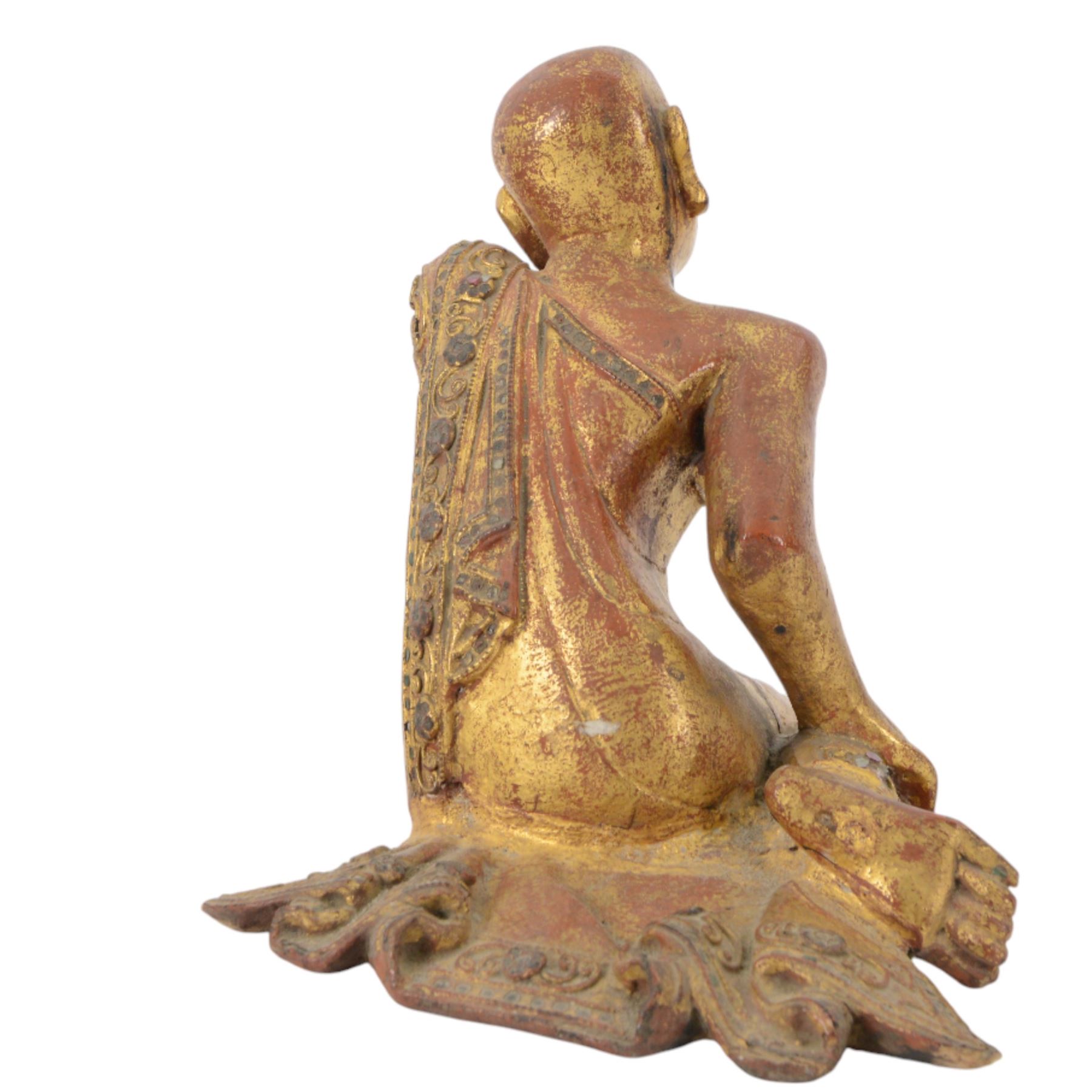 Late 19th century two Burmese Mandalay lacquered and gilt wood figures of monks, the robes edged with colored glass inlay and leafy scroll bands in raised lacquer, H25cm