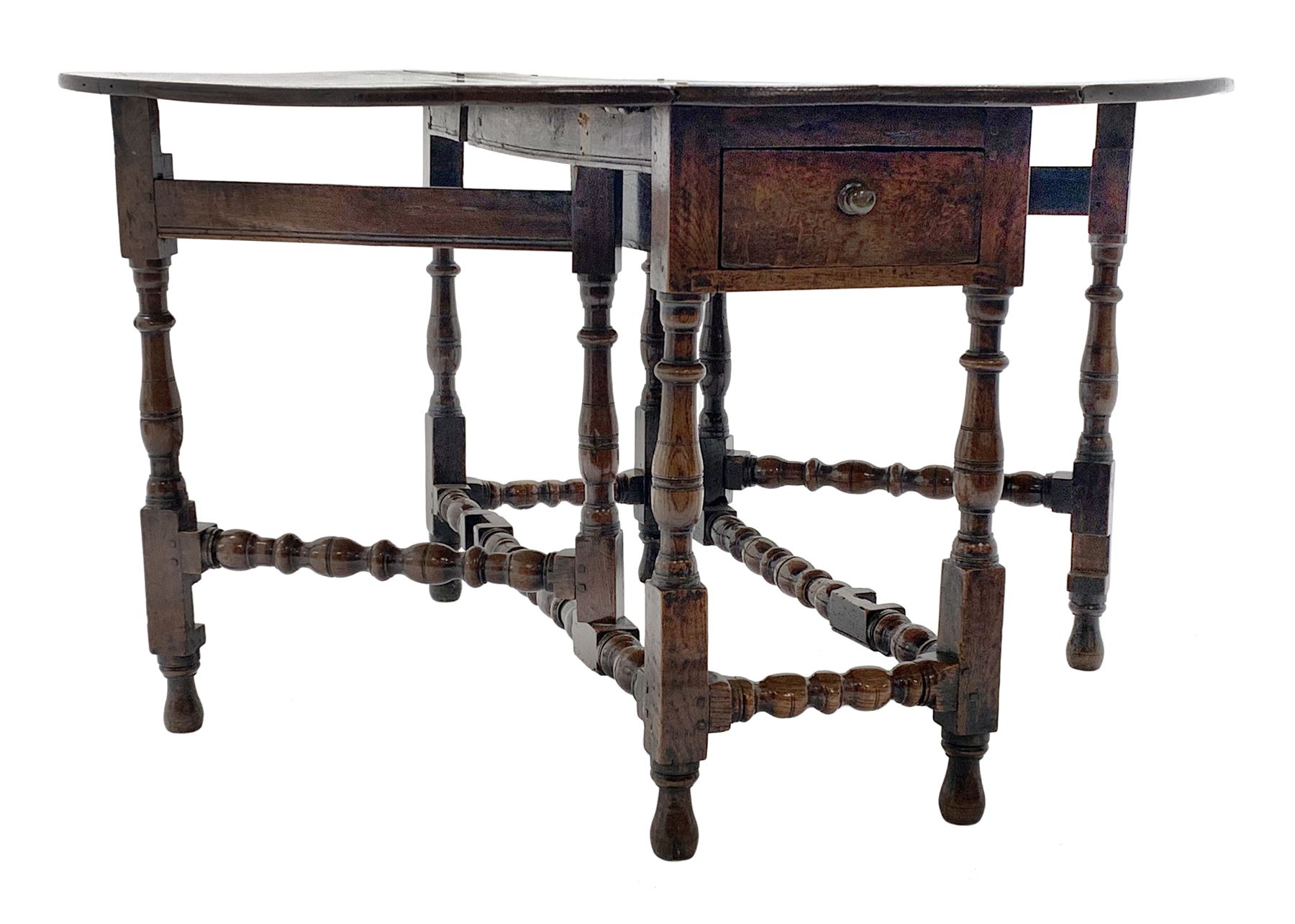 Late 17th century William & Mary oak drop leaf dining table, oval drop leaf top, single drawer to one end, gate action base, turned supports joined by bobbin turned stretchers, 121cm x 135cm, H75cm (open)