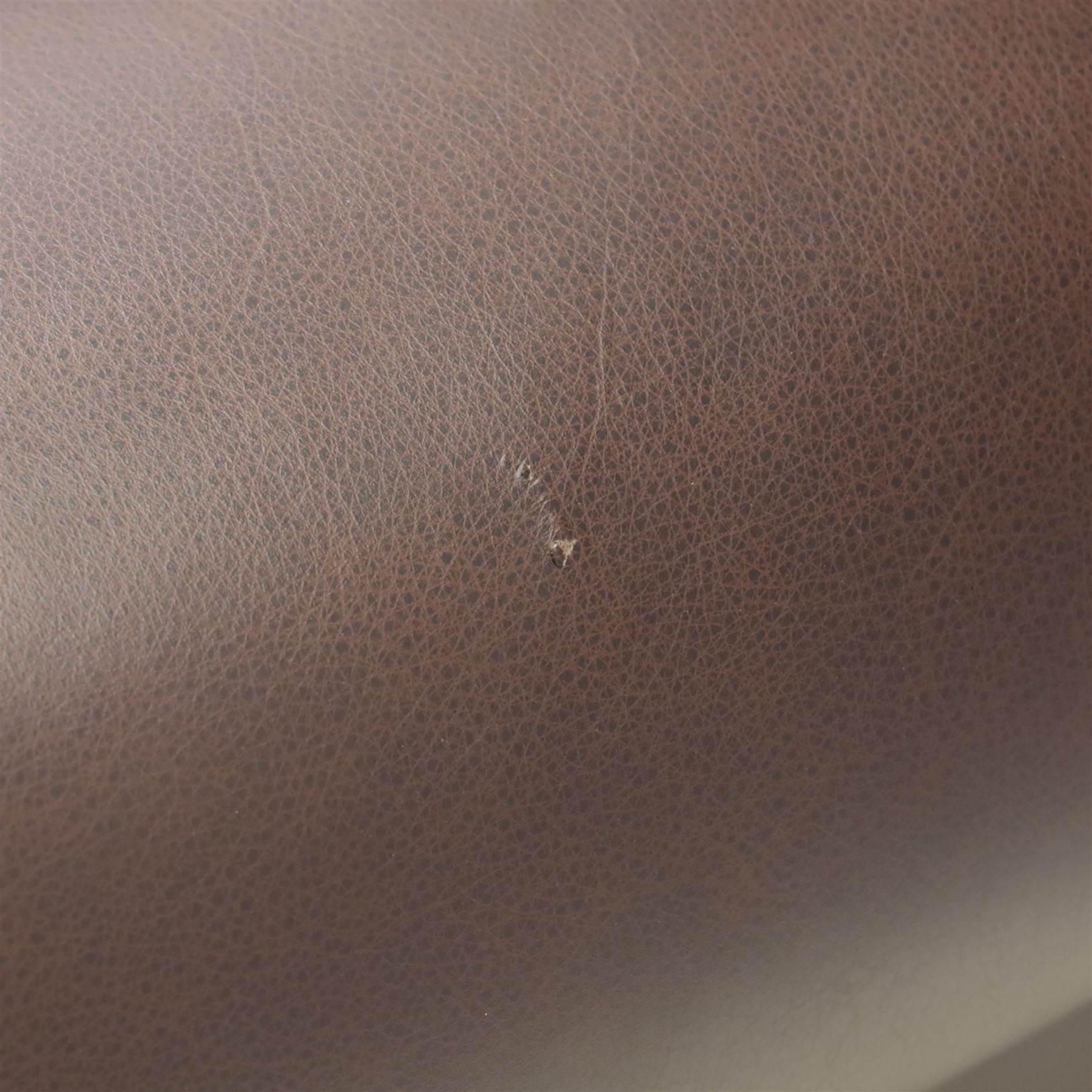 Laura Ashley - brown leather two seater sofa, loose cushion back and seat, flanked by scrolled arms upon light stained wood supports on castors