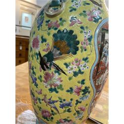 19th century Chinese famille rose yellow ground porcelain vase, of baluster form with twin applied mask ring handles, the body decorated with two shaped reserves mounted with dragon heads, depicting warriors at battle and at court, the neck with two smaller conforming figural reserves, upon a yellow ground decorated with exotic birds amidst scrolling blossom, H45.cm