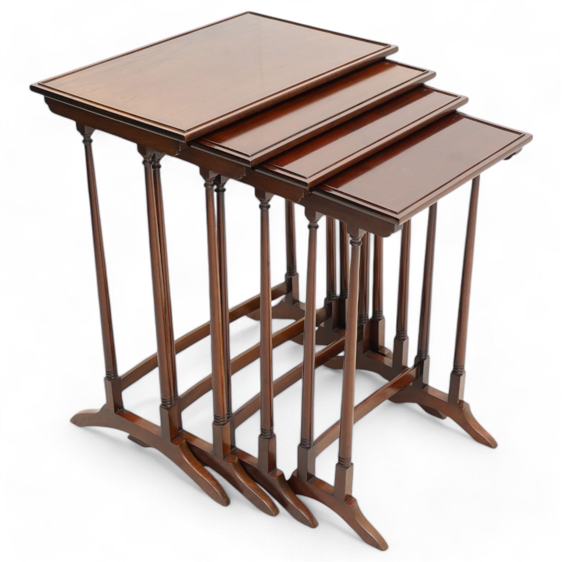 Early 20th century mahogany quartetto nest of four occasional tables, each with rectangular top with raised lip moulding, turned supports on splayed feet