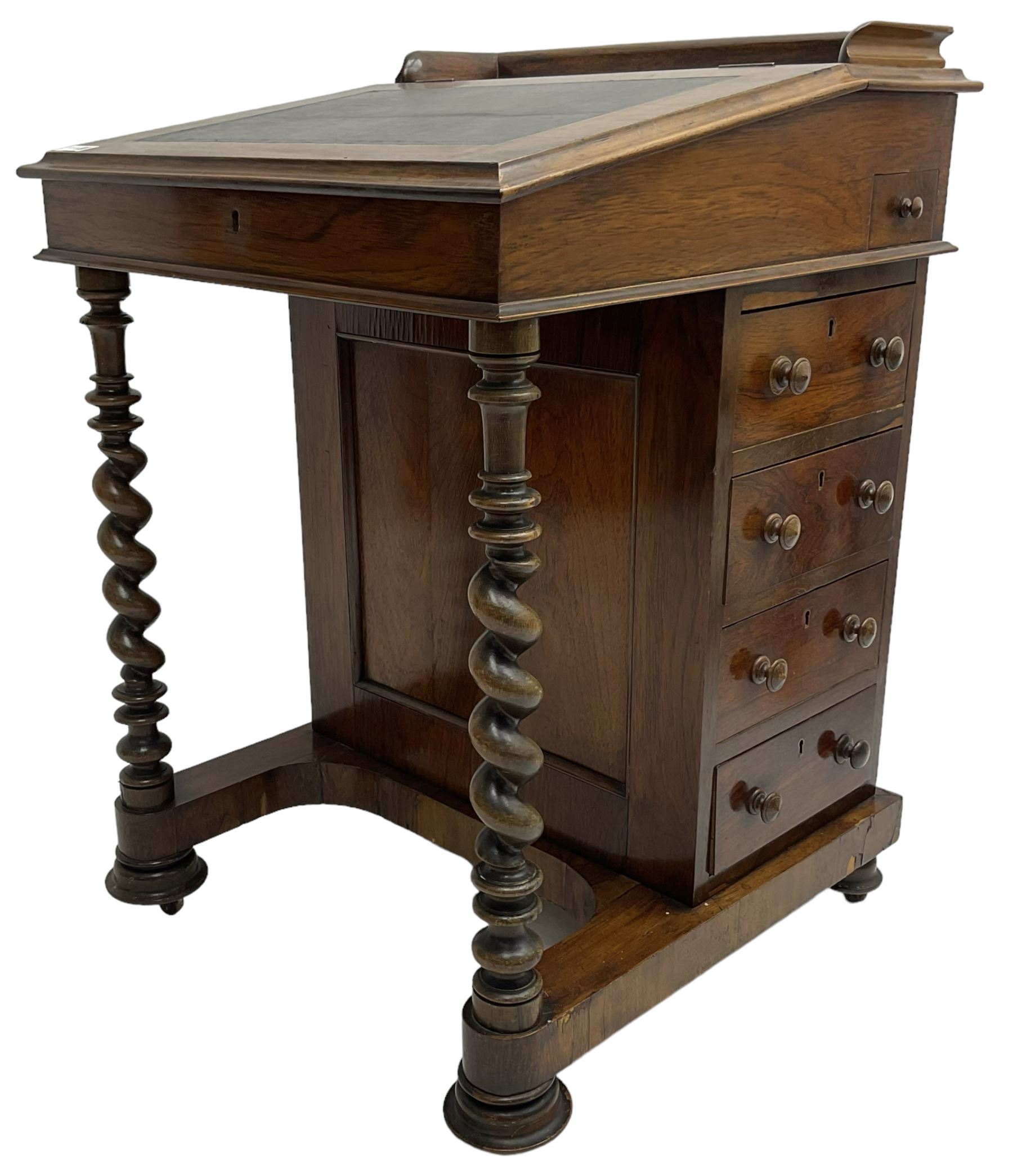Victorian walnut Davenport, hinged sloping top with inset leather writing surface, enclosing satinwood lined interior with two drawers over faux drawer, fitted with inkwell drawer and pen compartment to the side over four drawers with an opposing false set, raised on spiral turned supports united by a shaped platform base