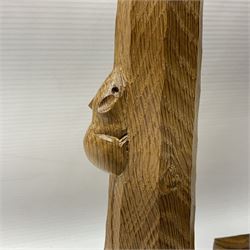 Mouseman - pair of tooled oak candlesticks, wrought iron sconce with drip tray over tapered octagonal column carved with mouse signature, terminating to stylised leaf carved square base, by the workshop of Robert Thompson, Kilburn
