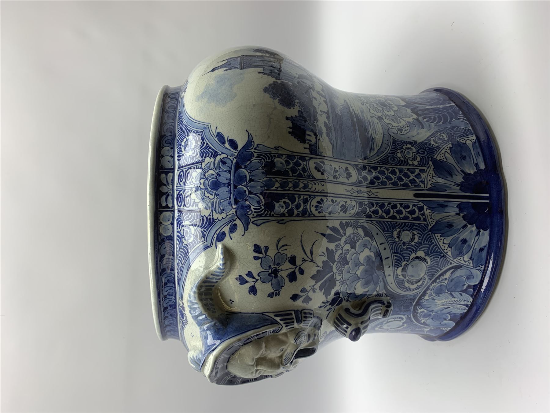 Large 20th century Delft blue and white jardinière, of baluster form with twin zoomorphic mask lug handles, decorated with hand painted panels of waterside scenes, within foliate surround, impressed and painted marks beneath for De Porceleyne Fles workshop, Delft, H35cm, rim D32