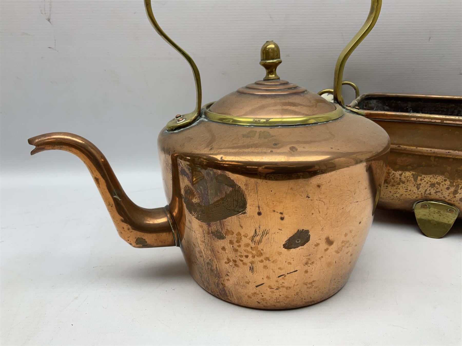 Copper planter of rectangular form with brass feet and twin handles, together with a brass mounted copper kettle, longest L54cm