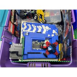 Lego - large quantity of part-built models and loose component parts including Lego Technic and Lego System, space and road vehicles, ships and boats, helicopter etc; together with two set boxes and folder  containing large quantity of instruction booklets; stored in two very large plastic boxes