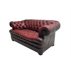 Chesterfield two seat sofa, upholstered in buttoned oxblood leather with studwork