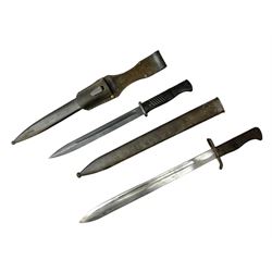 German Model 1884/98 knife bayonet, Third Reich period, with 25cm fullered steel blade; in steel scabbard with leather frog L41cm overall; and German Ersatz bayonet in steel scabbard marked Waffenfabrik Mauser A.G. Oberndorf & N (2)