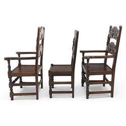 Early 20th century set of seven Jacobean Revival oak chairs, comprising pair of cavers and five chairs, each with carved mask and scroll decoration to the crest and and back rail, plain oak seat, upon turned front legs and block rear legs with conforming stretchers