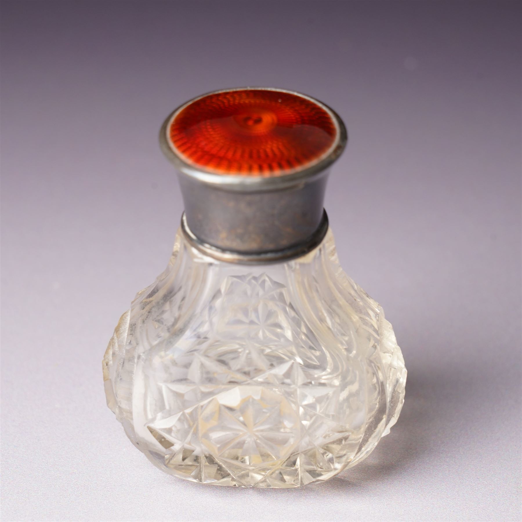 Small glass scent bottle with silver and red enamel cover, Edwardian silver cased scent flask with engraved decoration, heptagonal silver napkin ring, pair of small silver barrel shape salts, glass pepperette with silver and mother of pearl cover, small silver stone set fork by William Robb and a silver salt spoon