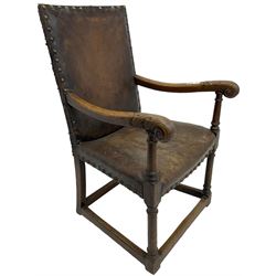 17th century design oak armchair, high back and seat upholstered in tan leather with studwork, scrolled arm terminals with carved acanthus detail, on turned supports united by box stretcher