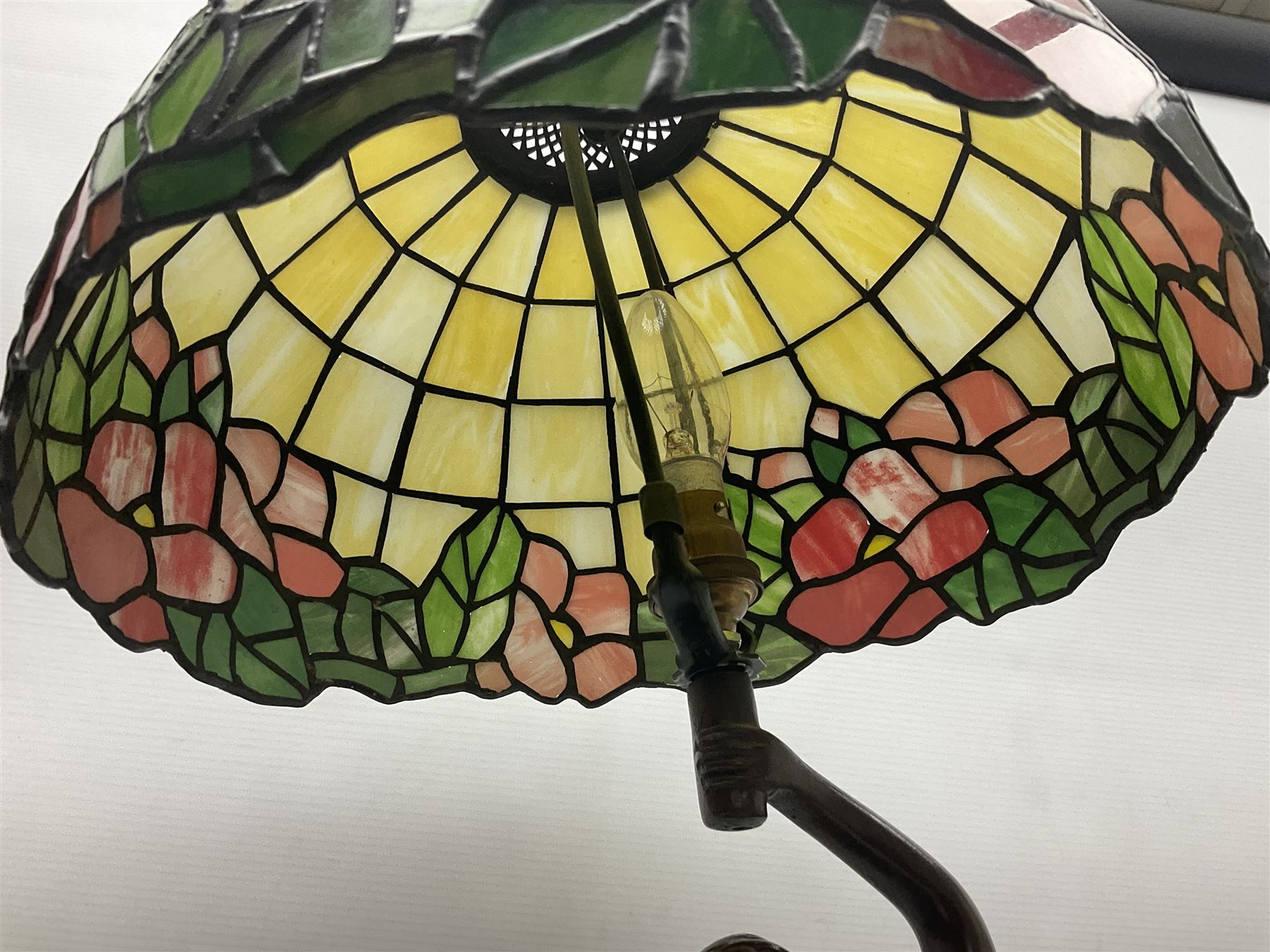 Tiffany style lamp in the form of a semi nude woman holding up a leaded lampshade together with a similar table lamp