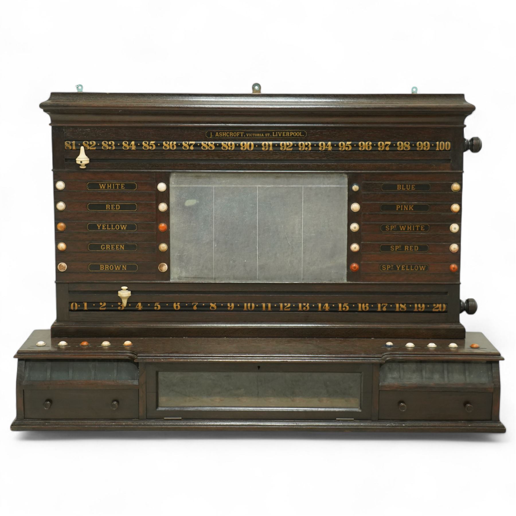 Victorian wall-mounted oak and walnut cased scoreboard,  moulded top, with a name stencilled in the frieze ‘J. Ashcroft, Victoria Street, Liverpool’, the board with chalk panel in the centre for recording scores, sliding panels on both sides for the various games of Billiards and Snooker, two numbered rotating arms with adjustable sliding score keepers, the base section with 5 apertures on each side, and coloured ivory roundels, all with glass front for viewing the tokens inside, with drawers beneath, the centre has a long glass panel for storing billiard balls, circa 1870 This item has been registered for sale under section 10 of the APHA Ivory Act Reference UNEGEBLB

