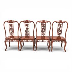 20th century Chinese ornately hardwood dining table and chairs, circular table with 'Lazy Susan' top with pierced carved frieze, raised on a quadriform base with carved foliate detail, the chairs en suite with carved pierced detailing  